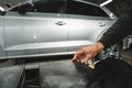 Close up of hands of car mechanic in auto repair service Royalty Free Stock Photo