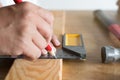 Close up hands of carpenter marking on wood. Royalty Free Stock Photo