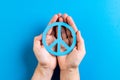 Close up of hands of caucasian woman holding peace sign with copy space on blue background Royalty Free Stock Photo