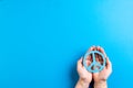 Close up of hands of caucasian woman holding peace sign with copy space on blue background Royalty Free Stock Photo