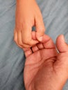 Close up of the hands of a child holding his mother's hand Royalty Free Stock Photo