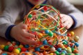 close-up of the hands of a child playing with multi-colored sensory balls generative ai