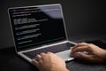 Close-up of hands coding on laptop, displaying programming interface. Represents software development, technology. Suitable for IT Royalty Free Stock Photo