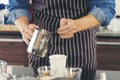 Close up hands coffee barista man make hot cup espresso shot from coffee machine. Cappuccino with milk in italian coffee shop cafe Royalty Free Stock Photo