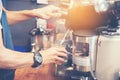 Close up hands coffee barista man make hot cup espresso shot from coffee machine. Cappuccino with milk in italian coffee shop cafe Royalty Free Stock Photo