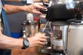 Close up hands coffee barista man make hot cup espresso shot from coffee machine. Cappuccino with milk in italian coffee shop cafe Royalty Free Stock Photo