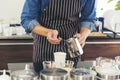 Close up hands coffee barista man make hot cup espresso shot from coffee machine. Cappuccino with milk in italian coffee shop cafe Royalty Free Stock Photo