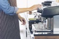 Close up hands coffee barista man make hot cup espresso shot from coffee machine. Cappuccino with milk in italian coffee shop cafe Royalty Free Stock Photo