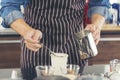 Close up hands coffee barista man make hot cup espresso shot from coffee machine. Cappuccino with milk in italian coffee shop cafe Royalty Free Stock Photo