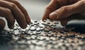 Two hands place the final pieces of a jigsaw puzzle together, symbolizing completion and problem-solving.
