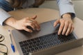 Close-up of the hands of a corporate woman dressed in a light blue formal shirt typing on her laptop Royalty Free Stock Photo