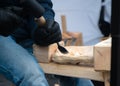 Close up of hands of craftsman carve with a gouge in the hands on the workbench in carpentry Royalty Free Stock Photo