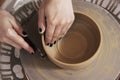 Close-up of the hands of a craftsman ceramist molding the clay i