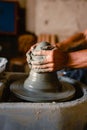 Close-up of the hands of the craftsman while creating a ceramic pot on the lathe Royalty Free Stock Photo