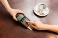 Close up of hands with credit card reader at cafe Royalty Free Stock Photo