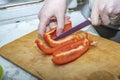 hands cut red pepper with a knife Royalty Free Stock Photo