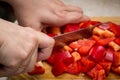 Close up of hands cutting vegetables with a knife