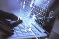 Close up of hands at desk using laptop with abstract glowing money mesh on blurry background. Cryptocurrency and online banking