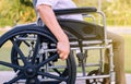 Close up of hands disabled woman sitting on wheelchair at outdoor
