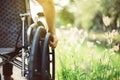 Close up of hands disabled woman sitting on wheelchair at nature in the morning