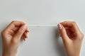 Close up of hands doing a french manicure on a white background, closeup view of a woman hand with a nail file and Royalty Free Stock Photo