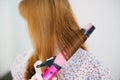 Close up of hands drying woman hair with equipment. Royalty Free Stock Photo