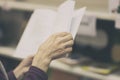 Close-up of hands of elderly person with open book, library. Toned background. Education concept, Self-study, reading Royalty Free Stock Photo
