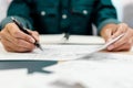 Close up hands of an engineer working and checking on blueprints. Engineer planning project on paperwork with equipment Royalty Free Stock Photo