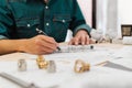 Close up hands of an engineer working and checking on blueprints. Engineer planning project on paperwork with equipment Royalty Free Stock Photo