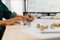 Close up hands of an engineer working and checking on blueprints. Engineer planning project on paperwork with equipment Royalty Free Stock Photo