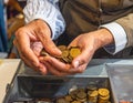 Close-Up of Hands Exchanging Coins at Cash Register Royalty Free Stock Photo