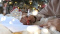 Close up hands of female writing letter and wish list at Christmas Eve. Girl writing in notebook. Woman hand holding pen Royalty Free Stock Photo