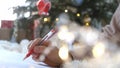 Close up hands of female writing letter and wish list at Christmas Eve. Girl writing in notebook. Woman hand holding pen Royalty Free Stock Photo