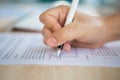 Close up of hands filling out employment application form with a pen. Royalty Free Stock Photo