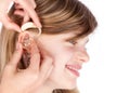 Close up of hands fitting a hearing aid to a happy young girl. I Royalty Free Stock Photo