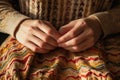 close-up of hands folding a sweater