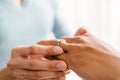 Close-up hands of gay couple, proposing and marriage surprise wear a wedding ring in the living room at home. Gay men proposal Royalty Free Stock Photo