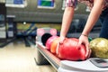 Close-up hands of girls take bowling ball Royalty Free Stock Photo