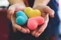 Close up hands giving colorful yarn heart handmade. Valentine da Royalty Free Stock Photo