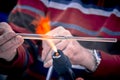Close-up of the hands of a glassblower working on a glass object. Royalty Free Stock Photo