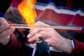Close-up of the hands of a glassblower working on a glass object. Royalty Free Stock Photo