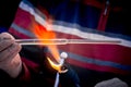 Close-up of the hands of a glassblower working on a glass object. Royalty Free Stock Photo