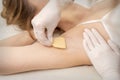 Beautician waxing young female armpit Royalty Free Stock Photo