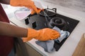 Close up hands with gloves cleaning the stove Royalty Free Stock Photo