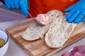 Chef preparing tasty fresh baguette sub sandwich. Royalty Free Stock Photo