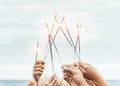 Close up hands of group of happy friends having fun celebrating with sparklers fireworks outdoor Royalty Free Stock Photo