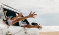 Happy family sitting in the car waving hands travel outside car windows Royalty Free Stock Photo