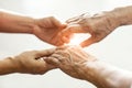 Close up hands of helping hands elderly home care. Mother and daughter