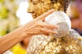 Close-up Hands holding a bowl of water to pour Buddha in the Songkran tradition. Hands of thai people pouring water bathing on