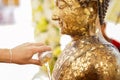 Close-up Hands holding a bowl of water to pour buddha in the Songkran tradition. Hands of thai people pouring water bathing on